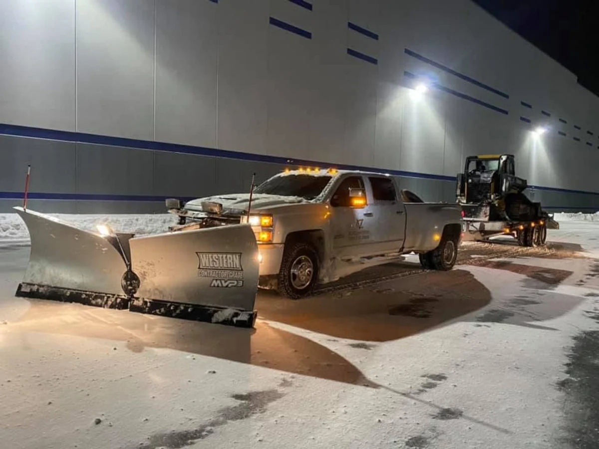 Snowplow truck outside a warehouse during emergency commercial snow removal in Wind Gap, Pennsylvania.